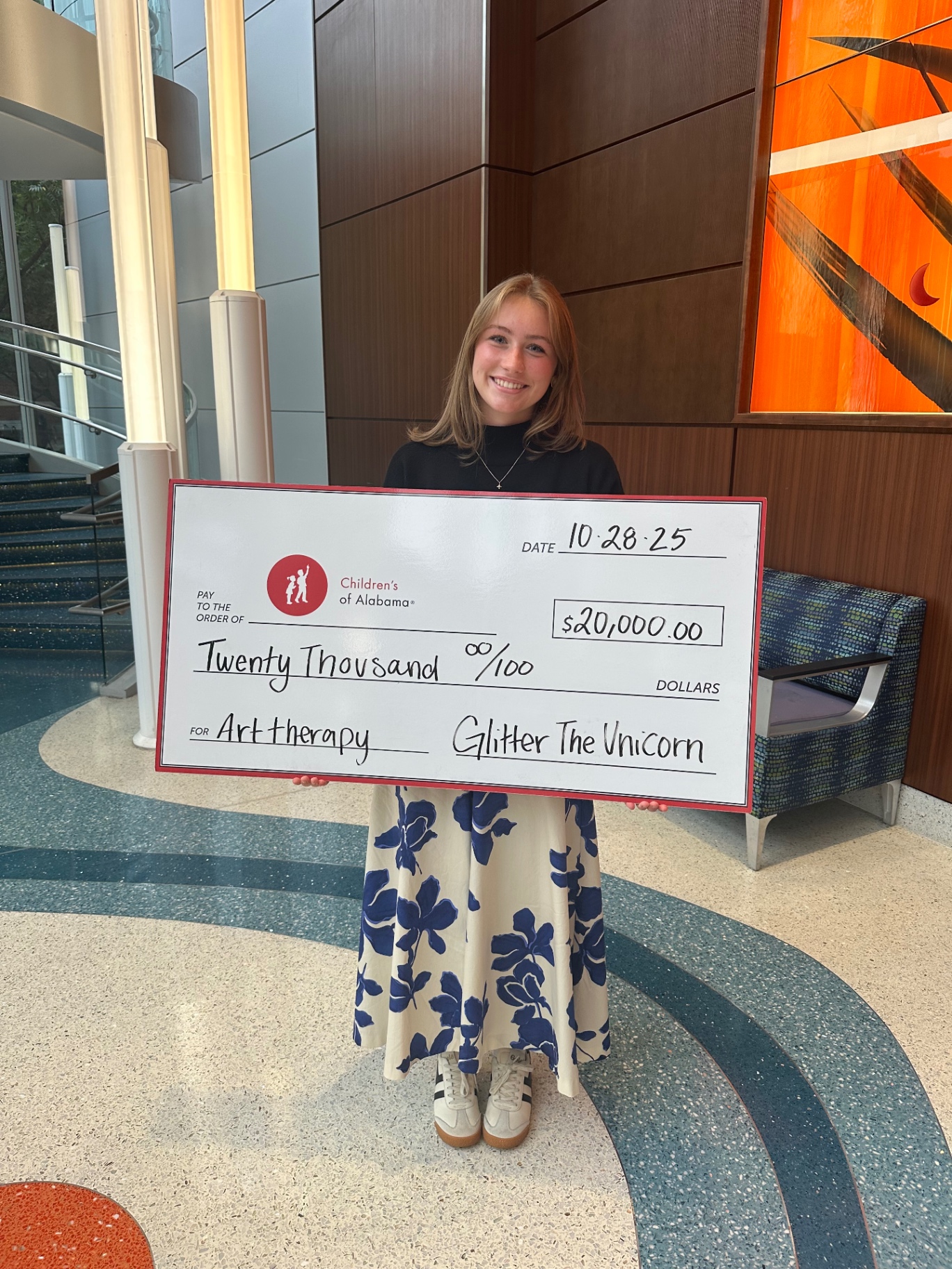 Callie presenting a $20,000 check to Children's of Alabama for art therapy, October 2025